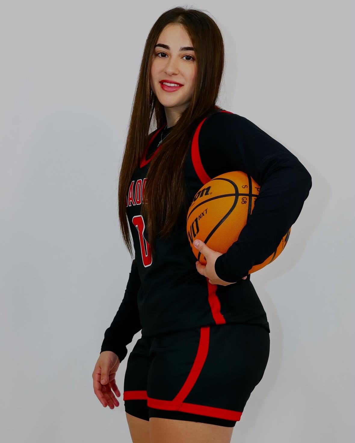 Coach Alique holding a basketball